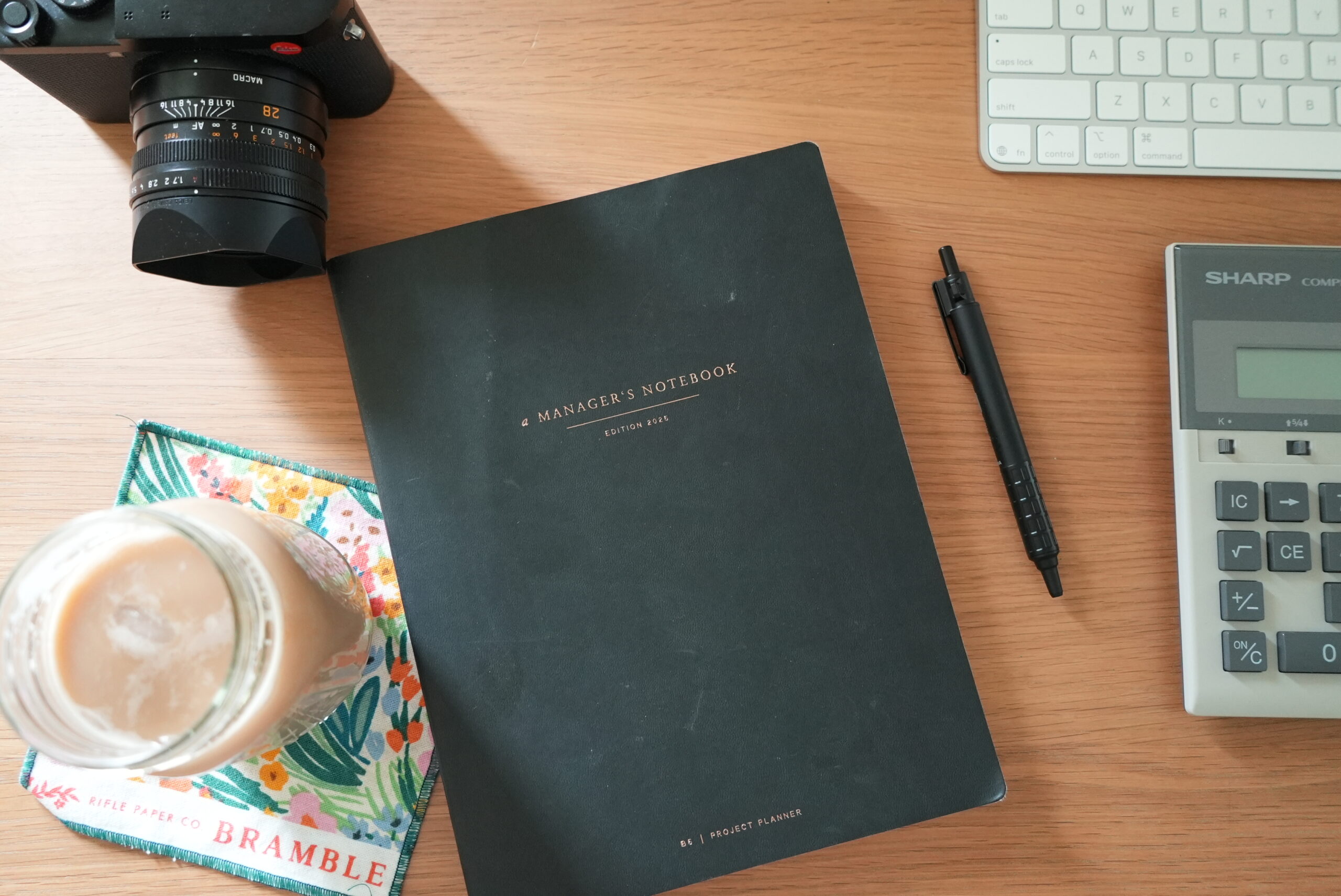 Warm latte on a patterned coaster, photographed from above, symbolizing a calm planning session.